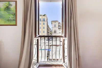 a room with a window with a view of a city at Campo dei Fiori Luxury Gold in Rome