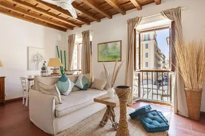 a living room with a couch and a window at Campo dei Fiori Luxury Gold in Rome
