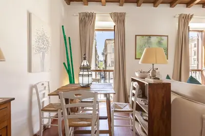 a living room with a table and chairs and a couch at Campo dei Fiori Luxury Gold in Rome