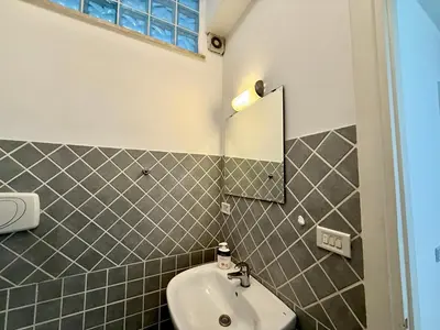 a bedroom with a bed and a window and a fan at Marconi Living in Rome