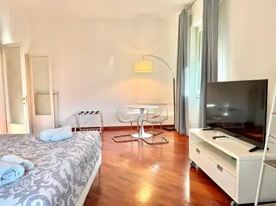 a bedroom with a bed and a television in a room at Marconi Living in Rome
