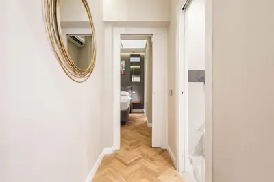 a hallway with a mirror on a wall at Spanish Steps Modern Gem in Rome
