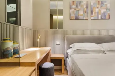 a bedroom with a bed and a desk with a lamp at Spanish Steps Modern Gem in Rome