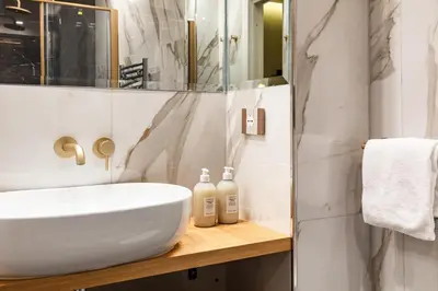 a bathroom with a white sink and a mirror at Spanish Steps Modern Gem in Rome