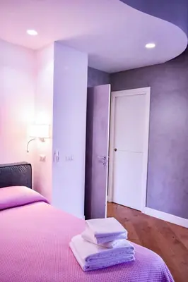 a bedroom with a bed with towels on it at Domus DiDio in Rome