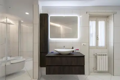 a bathroom with a sink and a tub and a mirror at Domus DiDio in Rome