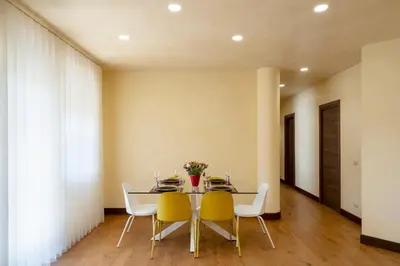 a dining room with a table and chairs at Domus DiDio in Rome