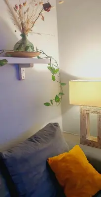 a room with a bed and a vase on a shelf at casa Gesi in Rome