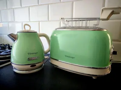 two green toasters sitting on top of a kitchen counter at casa Gesi in Rome