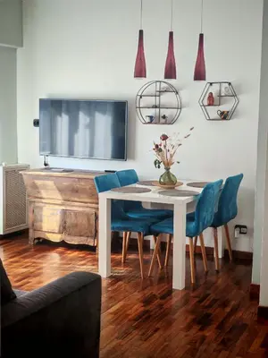 a dining room with a white table and blue chairs at casa Gesi in Rome