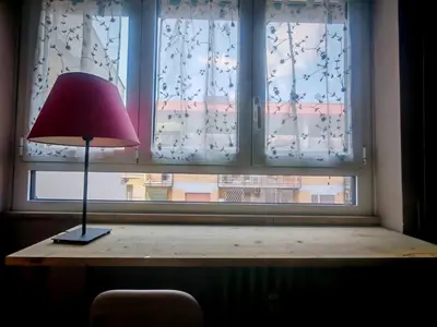 a lamp sitting on a table in front of a window at casa Gesi in Rome