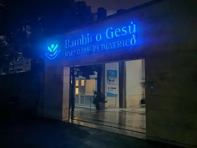 a building with a blue neon sign on it at casa Gesi in Rome