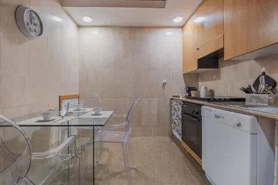 a kitchen with a table and chairs in a room at Exclusive Campo dei Fiori Flat in Rome