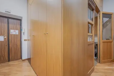 a hallway with wooden cabinets in a room at Exclusive Campo dei Fiori Flat in Rome
