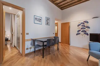 a dining room with a table and chairs at Exclusive Campo dei Fiori Flat in Rome