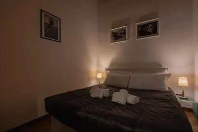 a bedroom with a bed with two towels on it at Exclusive Campo dei Fiori Flat in Rome