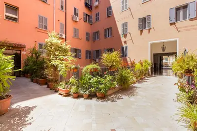 a courtyard with potted plants in front of a building at Koma 7 Apartment in Rome