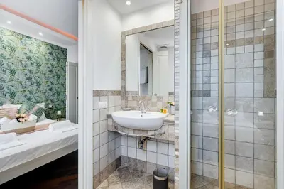 a bathroom with a sink and a shower at Koma 7 Apartment in Rome
