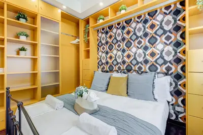 a bedroom with a bed and shelves at Koma 7 Apartment in Rome