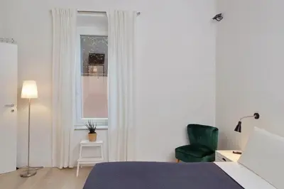 a bedroom with a bed and a chair and a window at Colosseo Mon Amour in Rome