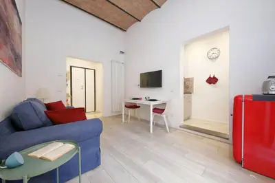 a living room with a blue couch and a table at Colosseo Mon Amour in Rome