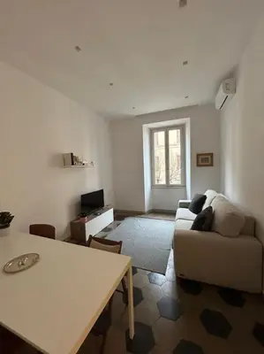 a living room with a couch and a table at Appartamento Ostiense CasaFrai in Rome