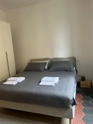 a bed in a room with two towels on it at Appartamento Ostiense CasaFrai in Rome