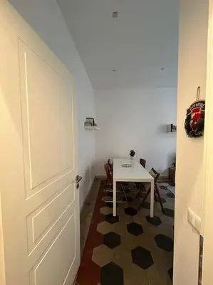 a room with a table and a white door at Appartamento Ostiense CasaFrai in Rome