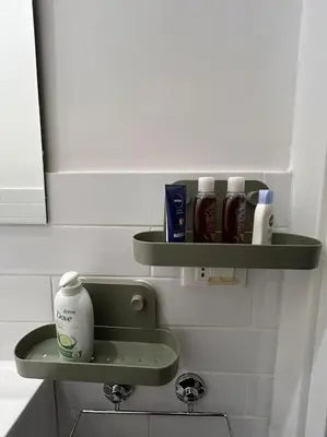 a bathroom with two green shelves on the wall at Appartamento Ostiense CasaFrai in Rome