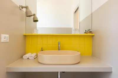 a bathroom with a sink and a mirror at La Stella Apartment by Hostand in Rome
