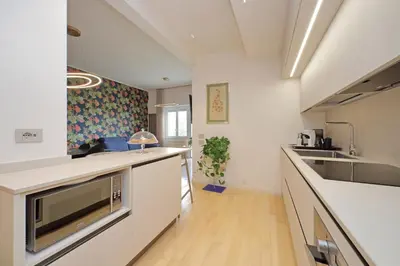 a kitchen with white counters and a sink and a counter top at On Rome Affittacamere o GuestHouse in Rome