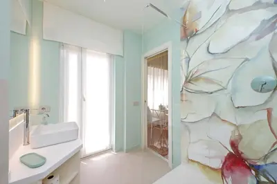 a bathroom with a sink and a wall mural at On Rome Affittacamere o GuestHouse in Rome
