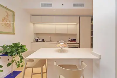a kitchen with a white table and chairs at On Rome Affittacamere o GuestHouse in Rome