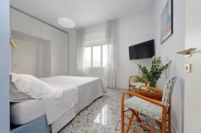 a bedroom with a bed and a chair and a tv at On Rome Affittacamere o GuestHouse in Rome