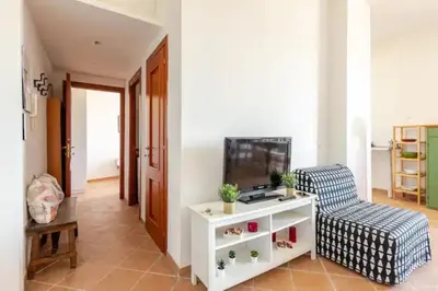 a living room with a tv and a chair at Porta Maggiore Cozy Apartment in Rome