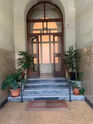 an entrance to a building with a door and some plants at Porta Maggiore Cozy Apartment in Rome
