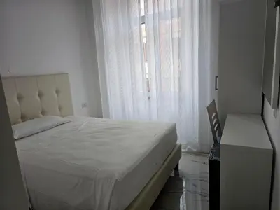 a bedroom with a white bed and a window at Aris Square Rome in Rome