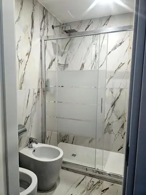 a bathroom with a shower and a sink and a toilet at Aris Square Rome in Rome
