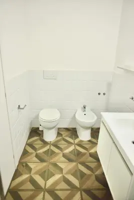 a white bathroom with a toilet and a sink at Apartment 29 in Rome
