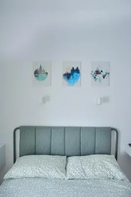 a bed in a bedroom with four pictures on the wall at Apartment 29 in Rome