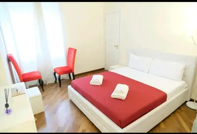 a bedroom with a bed with two towels on it at Sina Rent Room Flaminio in Rome