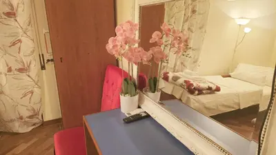 a room with a table and a mirror and a bed at Sina Rent Room Flaminio in Rome
