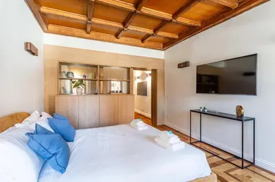 a bedroom with a large white bed with a flat screen tv at iFlat Campo dei Fiori View and SPA in Rome