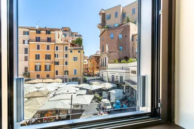 a window with a view of a city with buildings at iFlat Campo dei Fiori View and SPA in Rome