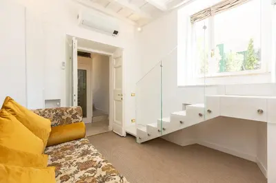 a living room with a couch and a window at Amazing Domus Ruspoli in Rome