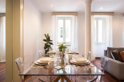 a dining room with a glass table and chairs at Boschetto Boutique Apartment in Rome