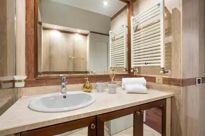 a bathroom with a sink and a mirror at Boschetto Boutique Apartment in Rome