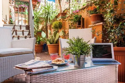 a table with a laptop computer on a patio at Castel Bolognese in Rome