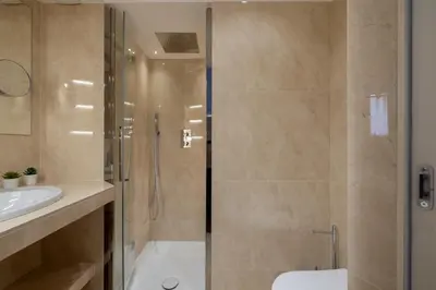 a bathroom with a shower and a toilet and a sink at The Best Rent - One-bedroom flat in Tritone area in Rome
