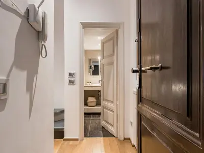 a hallway with a door leading to a bathroom at The Best Rent - One-bedroom flat in Tritone area in Rome